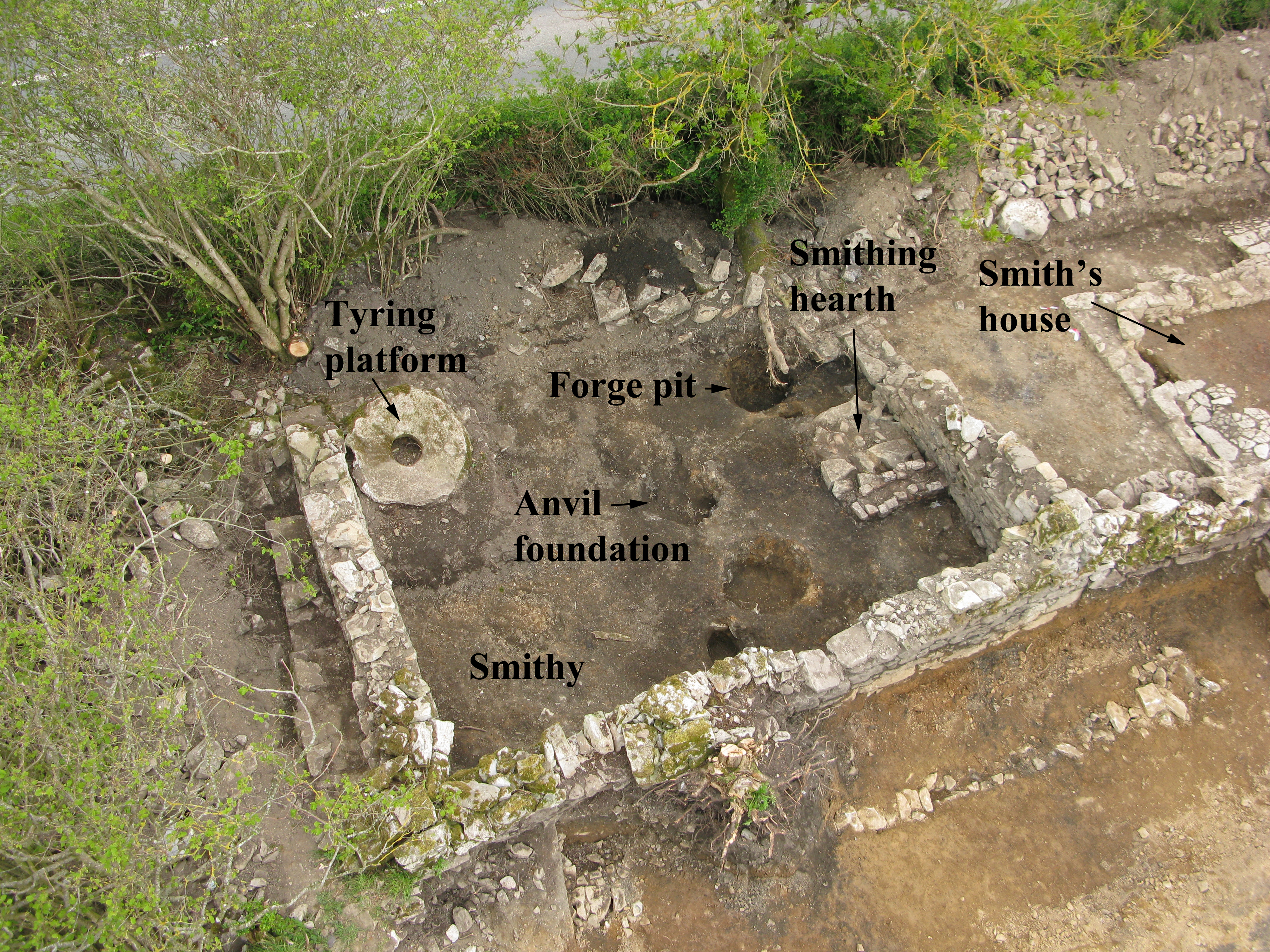 Illus. 3: Aerial view of excavated smithy at Clenor South. Note tyring platform. South to top of image (Photo: Airshots).